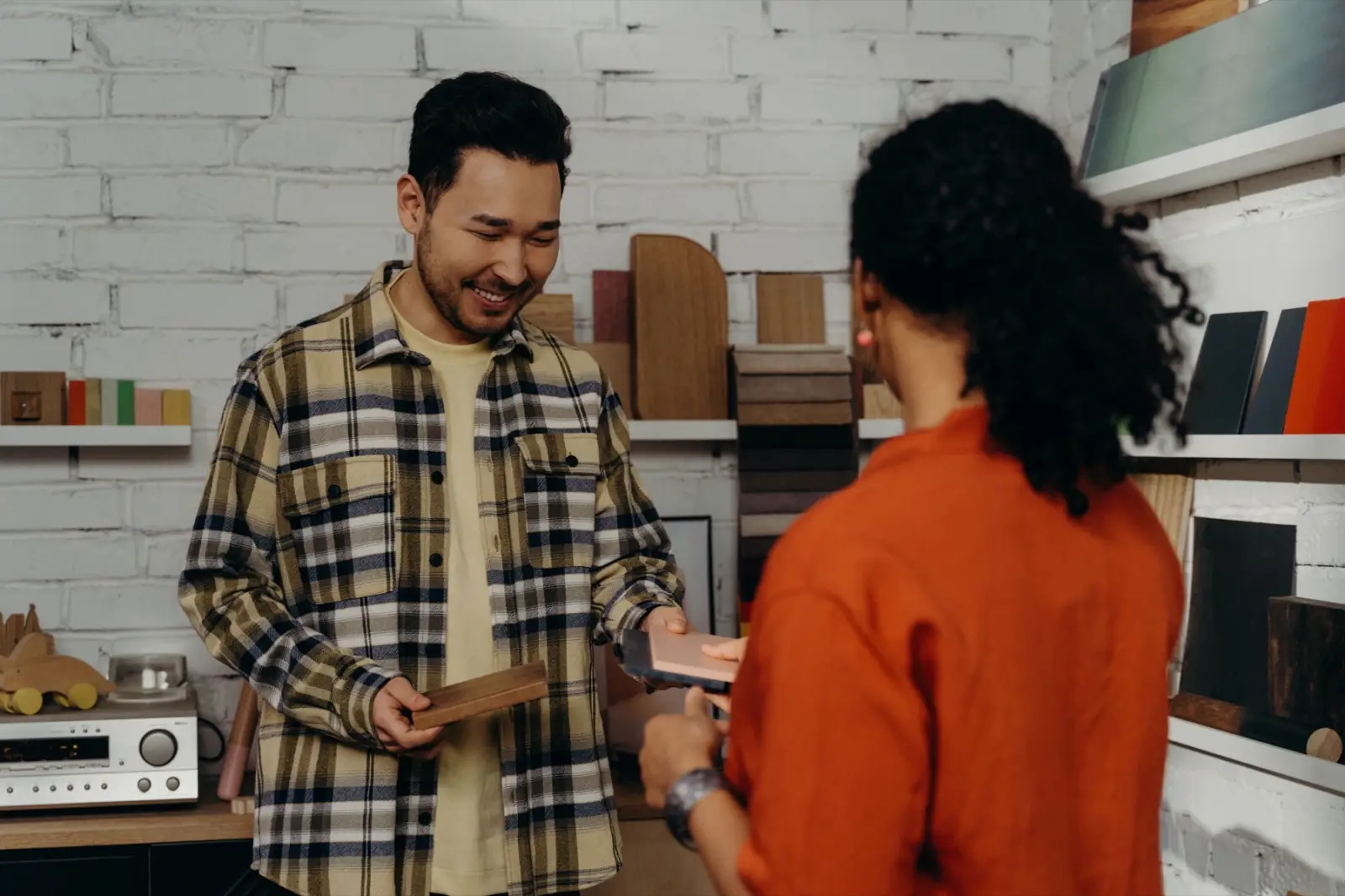 A workshop owner talking with a customer over materials